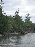 [Picture: Beach with overgrown cliffs]