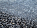 [Picture: Wet pebbles at the edge of the shore 2]