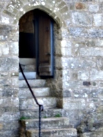 [picture: Stone steps leading up to a chapel door]