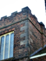 [picture: Stone facing work on brick tower]