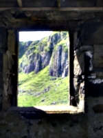 [picture: Cliff seen though old window]