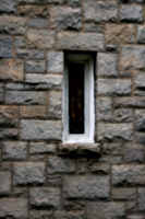 [picture: Stained-glass window in stone wall]